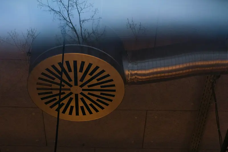 Round ceiling air diffuser connected to metal ductwork