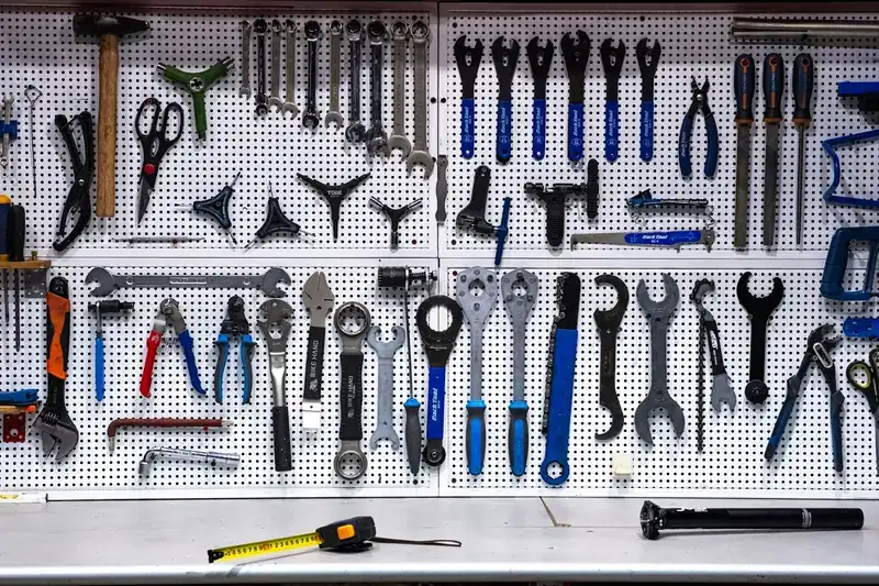 Wrenches, pliers, and hand tools organized on a pegboard