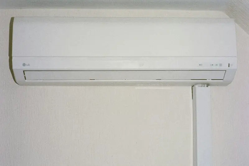 White ductless mini-split indoor unit mounted high on a wall